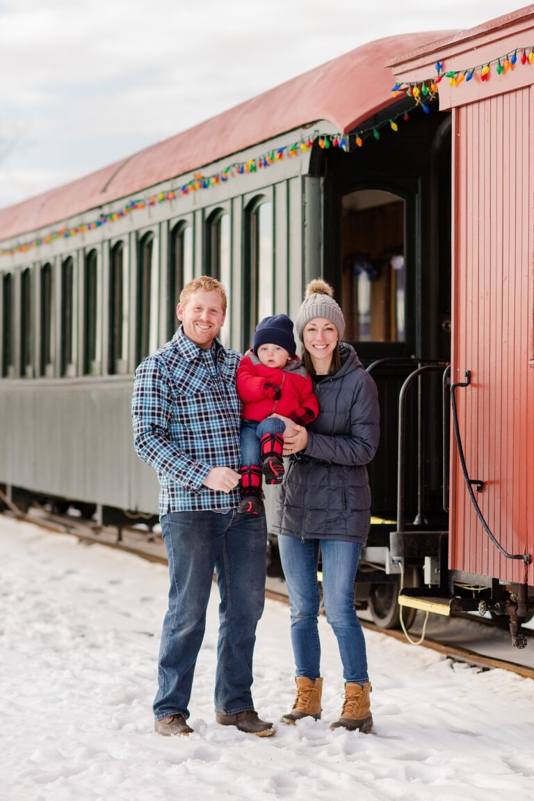 mom-dad-with-baby-son-posing-in-front-of-train