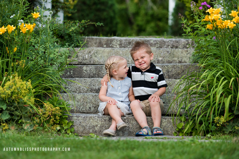 young-siblings-sitting-on-stone-steps