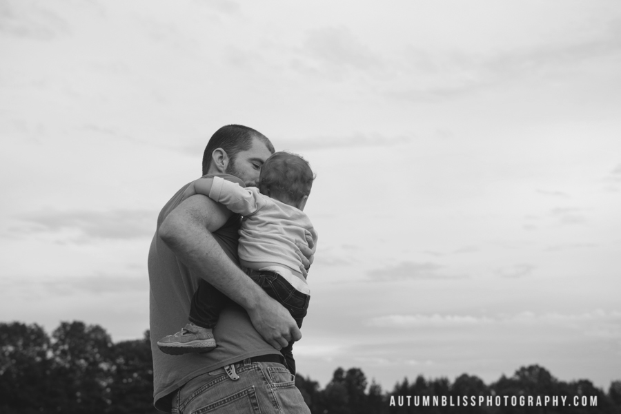 father-holding-daughter-facing-their-back