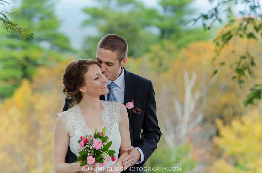 bride-and-groom-kissing-posing-scenic-foliage-maine