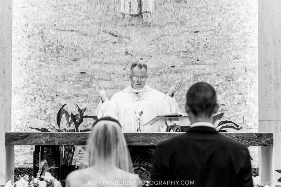 priest-hands-raised-and-back-of-bride-and-groom