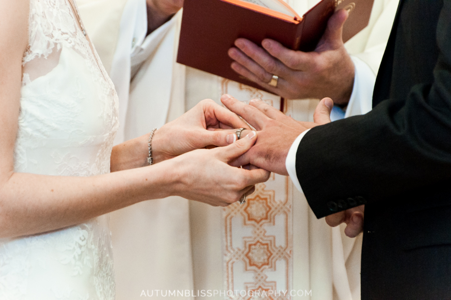 closeup-of-bride-slidding-ring-on-grooms-finger