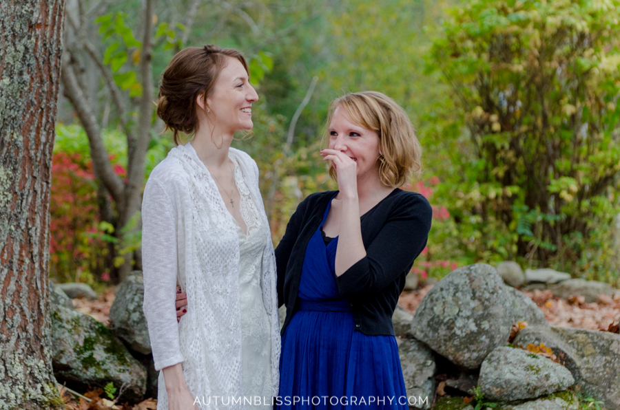 bride-and-sister-laughing-outdoors-clay-hill-farm-cape-neddick-maine