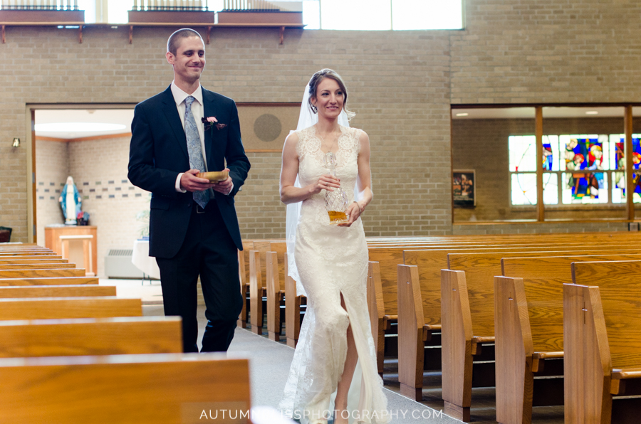 bride-groom-walking-down-aisle-with-vessels-for-communion-catholic-wedding