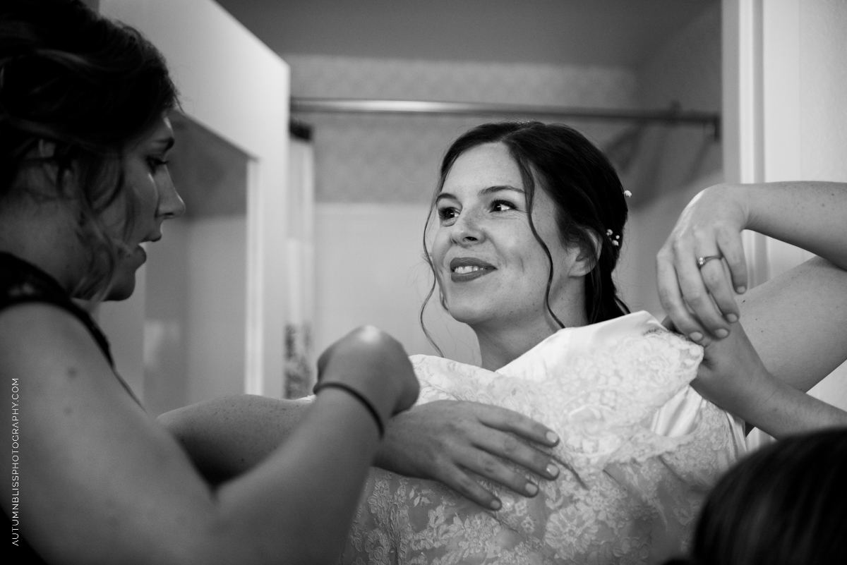 bride-getting-dress-on