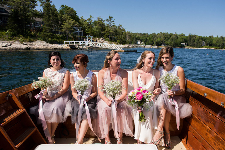 bride-and-bridesmaids-laughing-in-boat
