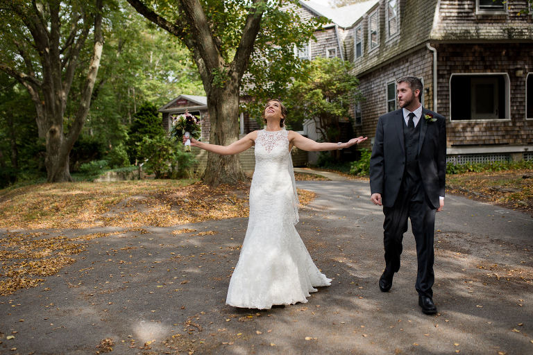 bride-walking-with-groom-arms-outstretched-looking-at-sky