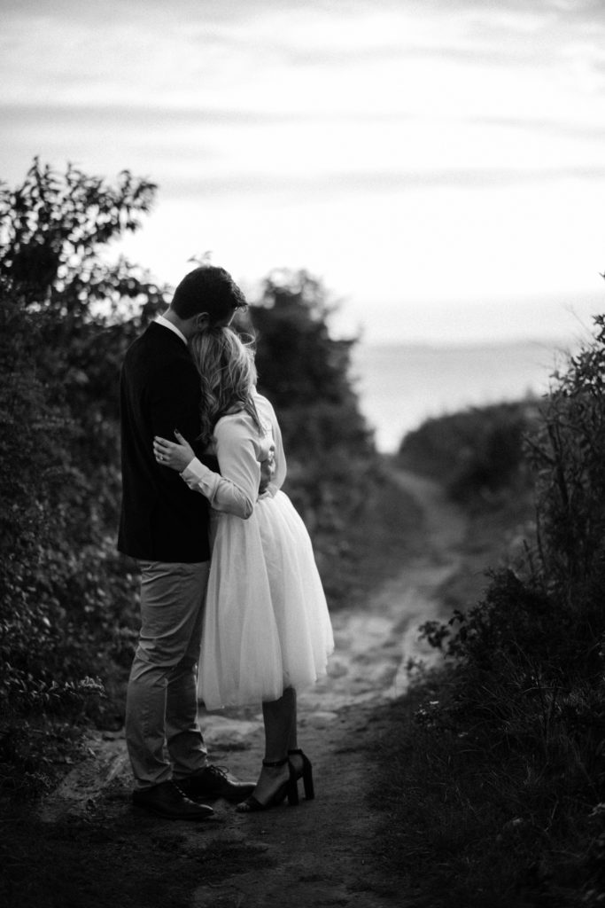 couple-looking-away-at-ocean-bw