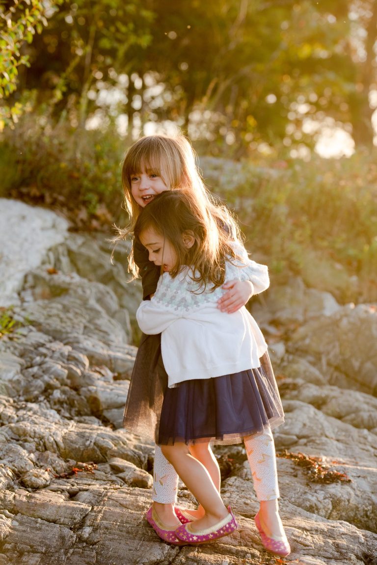 young-sisters-hugging-in-sunset