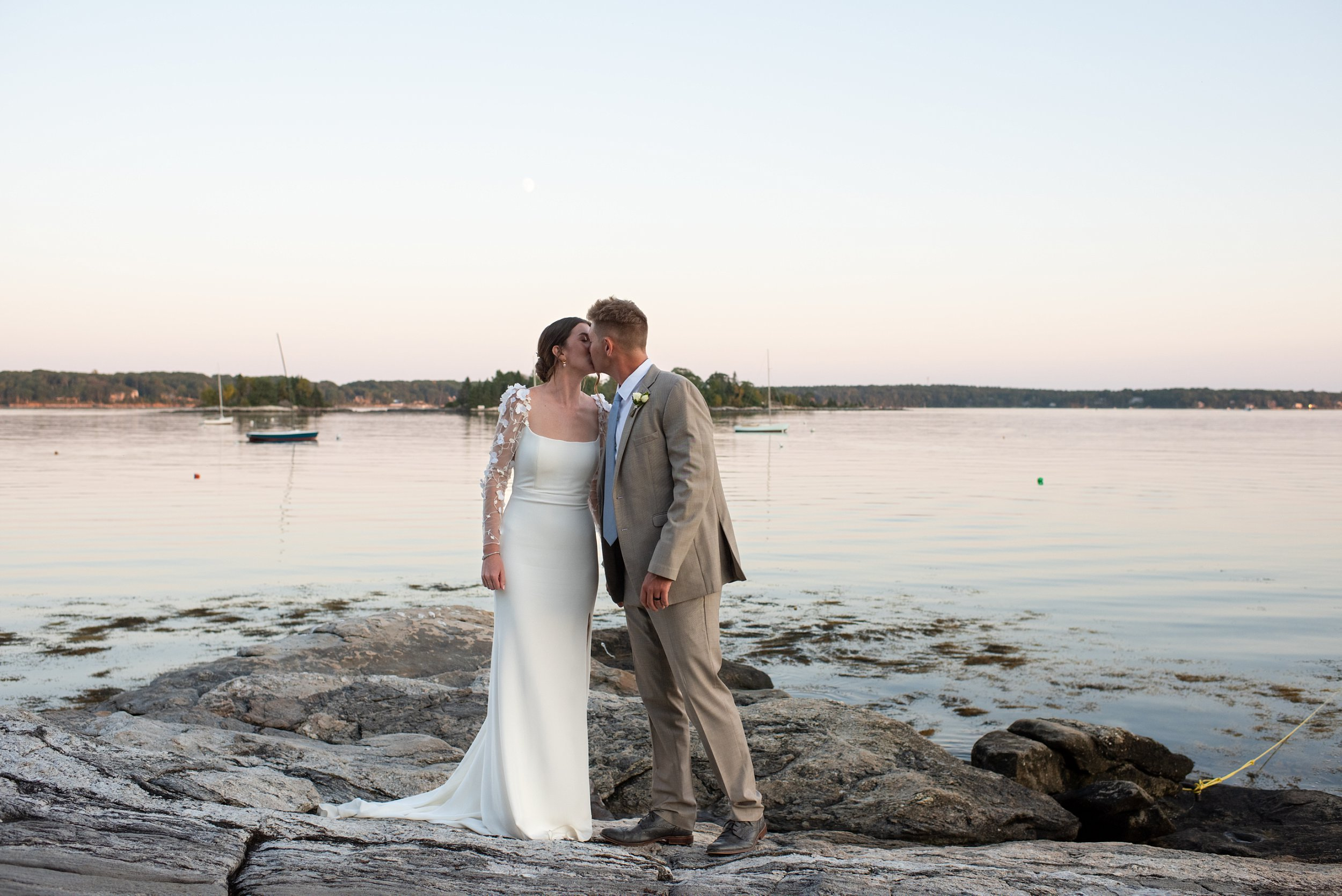 bride-groom-kissing-on-rocky-midcoast-maine-shore-at-sunset